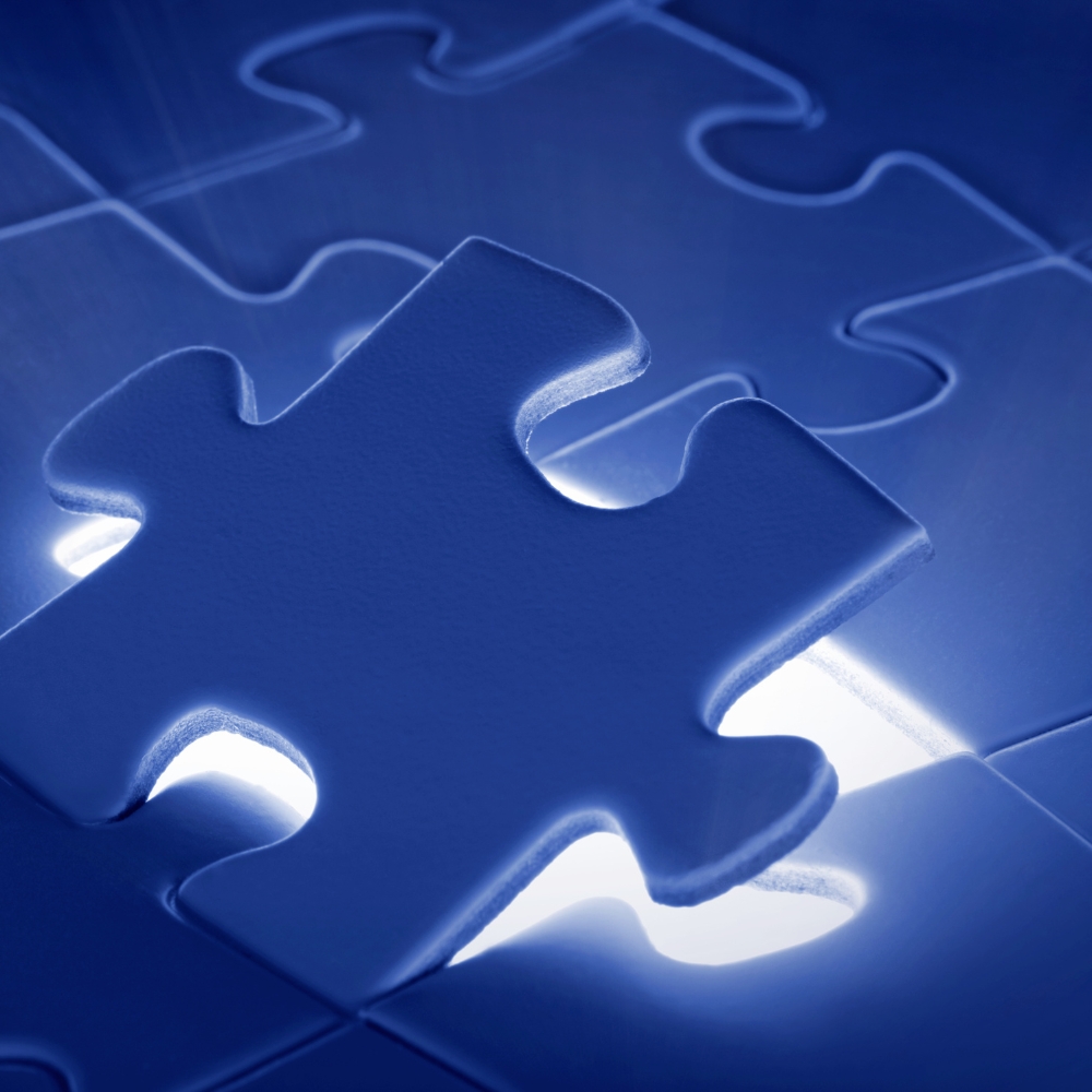 Close-up of a glowing puzzle piece fitting into place, symbolizing problem-solving and IT solutions.